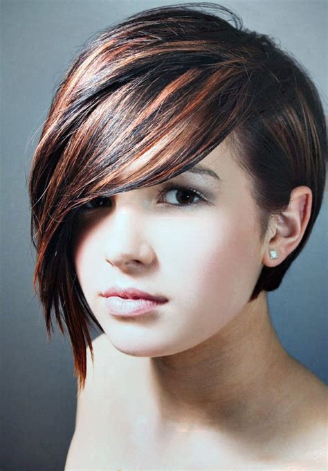 Long bang short hairstyles - The bangs are straight and sleek, adding attention to the cheekbones. The long side bang is curled tightly so that it adds some texture to the hair. The rest of the hair is perfectly molded into tighter curls that look lovely with the soft brown highlights. The long side bang is tucked under the curls of the hair. 